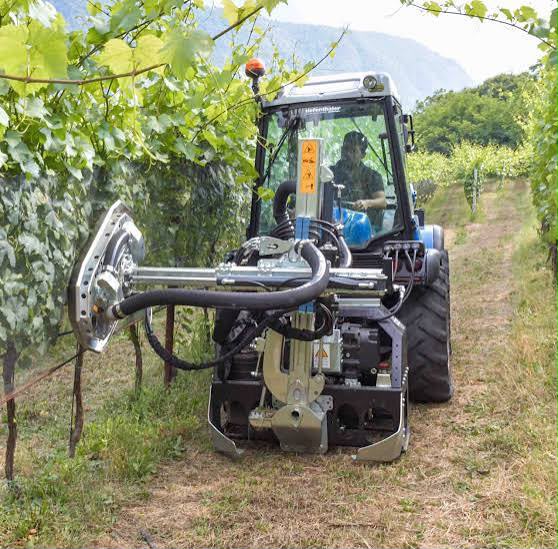 Attrezzatura montata su trattore durante il lavoro in vigneto